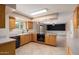 Spacious kitchen featuring wood cabinetry, stainless steel appliances, and a bright open floor plan at 3010 E Cortez St, Phoenix, AZ 85028