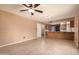 Open-concept living area with tile flooring and a breakfast bar connecting to the kitchen at 3010 E Cortez St, Phoenix, AZ 85028