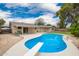 Backyard pool featuring a diving board, well-manicured landscaping, and a view of the covered patio at 3010 E Cortez St, Phoenix, AZ 85028