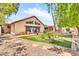 Relaxing backyard features a lush lawn, patio, desert plants, and a privacy fence for outdoor living at 3027 N Nebraska St, Chandler, AZ 85225