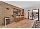 Stylish bar area adjacent to living room with brick accent wall, seating and a wine refrigerator at 3027 N Nebraska St, Chandler, AZ 85225
