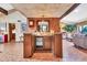 An open bar area featuring wooden cabinetry, granite countertops and easy access to the living room and kitchen at 3027 N Nebraska St, Chandler, AZ 85225