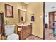 Cozy bathroom featuring tile floors, and a wood vanity topped with a sink and framed mirror at 3027 N Nebraska St, Chandler, AZ 85225