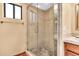 This bathroom features glass enclosed tiled shower with stone flooring, along with neutral wall paint at 3027 N Nebraska St, Chandler, AZ 85225