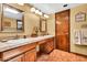 A cozy bathroom showcases double sinks, framed mirrors, and traditional lighting fixtures at 3027 N Nebraska St, Chandler, AZ 85225