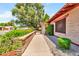 Walkway along the side of the home with manicured garden beds and a lovely shade tree at 3027 N Nebraska St, Chandler, AZ 85225
