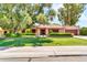Charming single-story home with a well-manicured front yard and mature trees at 3027 N Nebraska St, Chandler, AZ 85225