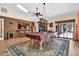 Spacious game room featuring a billiards table, wet bar, brick accent wall, and lots of natural light at 3027 N Nebraska St, Chandler, AZ 85225