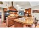 A charming kitchen features wood cabinets, tile flooring, an island cooktop, and granite countertops at 3027 N Nebraska St, Chandler, AZ 85225