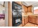 Contemporary kitchen equipped with built-in microwave and oven, along with ample cabinet space and stylish backsplash at 3027 N Nebraska St, Chandler, AZ 85225