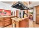 Functional kitchen island with granite countertop, black range hood and plenty of space for meal prep at 3027 N Nebraska St, Chandler, AZ 85225