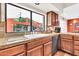 Kitchen sink with granite countertops, wooden cabinets, black dishwasher and a window view to the outside patio at 3027 N Nebraska St, Chandler, AZ 85225