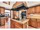 Elegant kitchen island featuring sleek cooktop, custom vent hood, and beautiful cabinets with plenty of storage at 3027 N Nebraska St, Chandler, AZ 85225