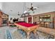 Open-concept living room features a stone fireplace, pool table, and bar area for entertaining guests at 3027 N Nebraska St, Chandler, AZ 85225