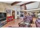 Cozy living room with a stone fireplace, wood beams, and tile flooring at 3027 N Nebraska St, Chandler, AZ 85225