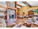 Expansive living room area with stone fireplace, beamed ceilings, dining table and views of the house at 3027 N Nebraska St, Chandler, AZ 85225