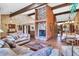 Spacious living room with vaulted ceilings, wood beams, and stone fireplace flowing into dining room at 3027 N Nebraska St, Chandler, AZ 85225