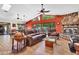 Bright living room featuring a stone fireplace, high ceilings, and large windows with a view of the backyard at 3027 N Nebraska St, Chandler, AZ 85225