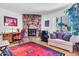 The living room features a stone fireplace, a desk area, a cozy couch, and natural light at 3027 N Nebraska St, Chandler, AZ 85225