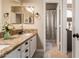 Bathroom featuring granite counters, light cabinets, elegant mirrors, and a separate toilet room at 3055 N Red Mountain -- # 98, Mesa, AZ 85207