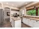 Open kitchen with granite countertops, stainless steel appliances, white cabinets and an island at 3055 N Red Mountain -- # 98, Mesa, AZ 85207