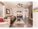 Open-concept living room featuring a stone accent wall, hardwood floors, and modern furniture at 3055 N Red Mountain -- # 98, Mesa, AZ 85207