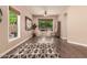 Bright living room with hardwood floors, two chairs, and a large window overlooking trees at 3055 N Red Mountain -- # 98, Mesa, AZ 85207