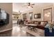 Living room with hardwood floors, comfortable seating, modern lighting and an adjacent kitchen at 3055 N Red Mountain -- # 98, Mesa, AZ 85207