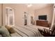 The main bedroom features an ensuite bathroom and a comfortable seating area with an entertainment center at 3055 N Red Mountain -- # 98, Mesa, AZ 85207