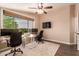 Bright office with neutral walls, ceiling fan, large window, and dual workstation desks at 3055 N Red Mountain -- # 98, Mesa, AZ 85207