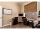 Neutral toned office with a dark wood desk, window, and workout equipment at 3055 N Red Mountain -- # 98, Mesa, AZ 85207