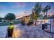 Spacious backyard with patio seating, built in bbq area, and lush green landscaping at 306 E Sarah Ln, Tempe, AZ 85284