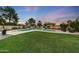 Lush backyard featuring manicured lawn and a sparkling pool, perfect for outdoor enjoyment at 306 E Sarah Ln, Tempe, AZ 85284