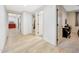 Hallway with bright white walls, wood-look tile floors, and open doorways at 306 E Sarah Ln, Tempe, AZ 85284