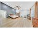 Well-lit main bedroom featuring a ceiling fan, wood floors, neutral decor, and ample space for seating at 306 E Sarah Ln, Tempe, AZ 85284