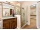 Bright bathroom features a glass enclosed shower, wood floors, granite countertop, and a walk-in closet at 30844 N 41St Pl, Cave Creek, AZ 85331