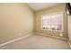 Empty bedroom features a window and tan walls with white baseboards and carpet at 30844 N 41St Pl, Cave Creek, AZ 85331