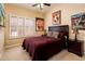 Charming bedroom with carpet, decorative posters, a ceiling fan, a window, and two matching nightstands at 30844 N 41St Pl, Cave Creek, AZ 85331