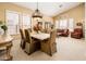 Elegant dining area bathed in natural light featuring modern chandelier and neutral color scheme at 30844 N 41St Pl, Cave Creek, AZ 85331