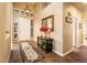 Bright foyer with white door, decorative mirror, rug, and neutral paint, creating a welcoming entrance at 30844 N 41St Pl, Cave Creek, AZ 85331