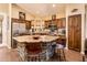 A kitchen with stone-clad island, stainless steel appliances, granite countertops, and wood cabinetry at 30844 N 41St Pl, Cave Creek, AZ 85331