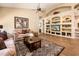 Living room features a ceiling fan, built-in shelving, and tile flooring for a modern and welcoming space at 30844 N 41St Pl, Cave Creek, AZ 85331