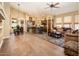 Open-concept living room with a stacked stone kitchen island, wood floors, and plenty of natural light at 30844 N 41St Pl, Cave Creek, AZ 85331
