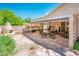 Charming outdoor patio with a built-in fireplace, stone flooring, and shaded pergola, perfect for entertaining at 30844 N 41St Pl, Cave Creek, AZ 85331