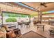 Spacious outdoor patio with a decorative fireplace, seating area, pergola, and a built-in grill at 30844 N 41St Pl, Cave Creek, AZ 85331