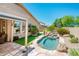 Inviting backyard pool with waterfall feature, artificial turf, and a private, landscaped setting at 30844 N 41St Pl, Cave Creek, AZ 85331