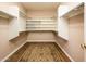 Spacious walk-in closet with wood floors and plenty of storage space for clothes and accessories at 30844 N 41St Pl, Cave Creek, AZ 85331