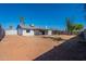 Backyard view of home and covered patio with mature landscaping and privacy fence at 3118 S Los Altos Dr, Mesa, AZ 85202