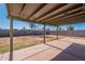 Covered patio overlooking the expansive backyard with block wall at 3118 S Los Altos Dr, Mesa, AZ 85202