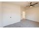 Spacious bedroom with a ceiling fan, carpet floors, and closet for storage at 3118 S Los Altos Dr, Mesa, AZ 85202